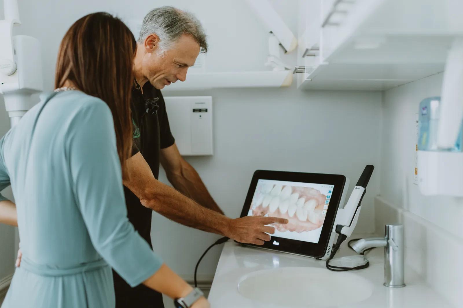 A clinician explaining a digital dental scan to a patient at Park Dental Care